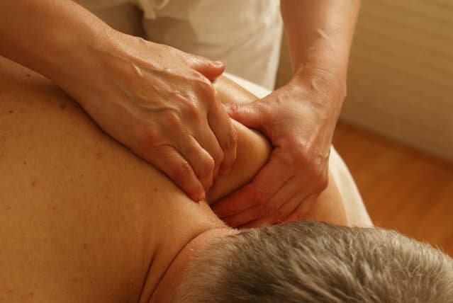 A man receiving a therapeutic shoulder massage.